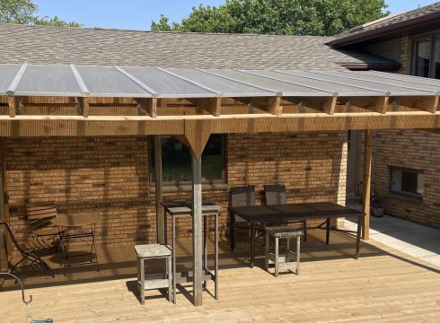 Skyview roof on a wood-beam structure shading a deck with bar seating