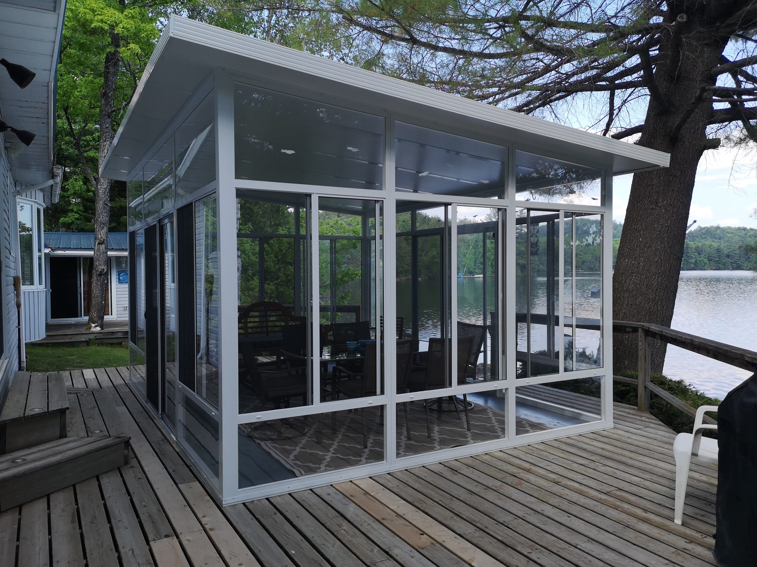 Freestanding aluminum luxury gazebo on a lakeside deck