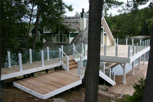 Warm cedar-tone composite decking on a lakeside dock and deck
